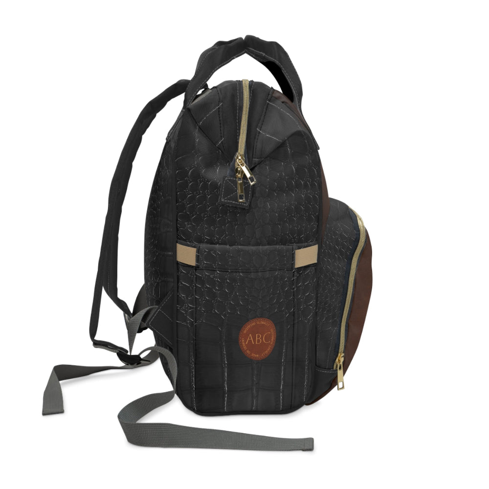 Briefcase Brown and Black quilted diaper backpack with "ABC" label on a white background