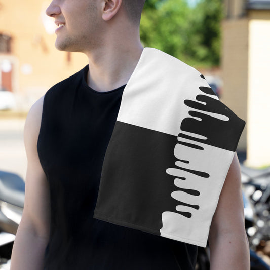 Dad wearing the chic bold drip black and white burp cloth on his shoulder outdoors.